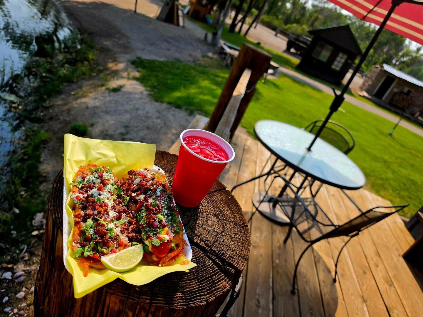 T&T Dynamite Taco Bar food and a drink by the pond at Mountain River Ranch in Ririe, Idaho